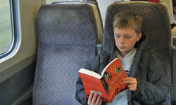 boy reading on the train